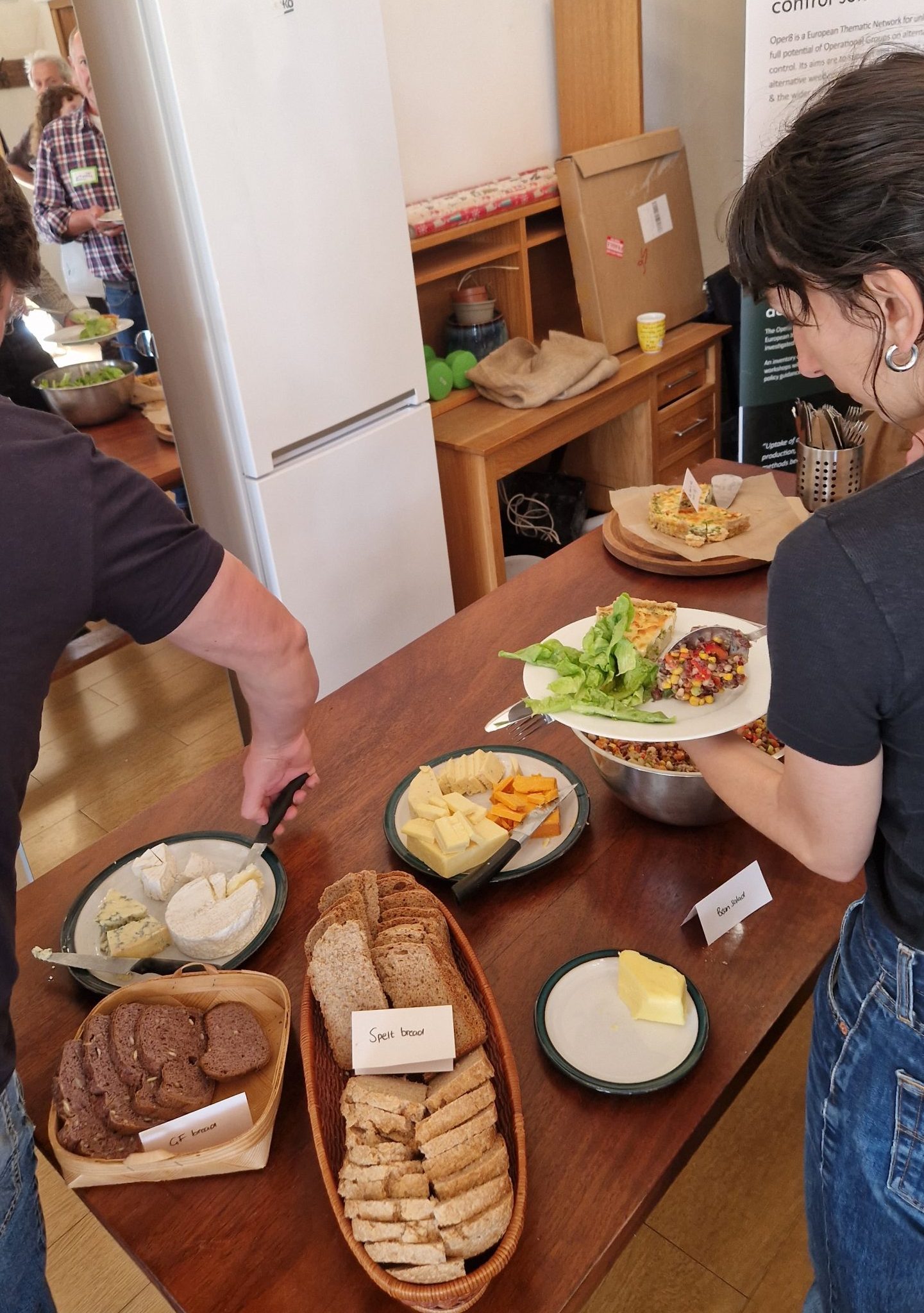 A person serving food at a lunch buffet