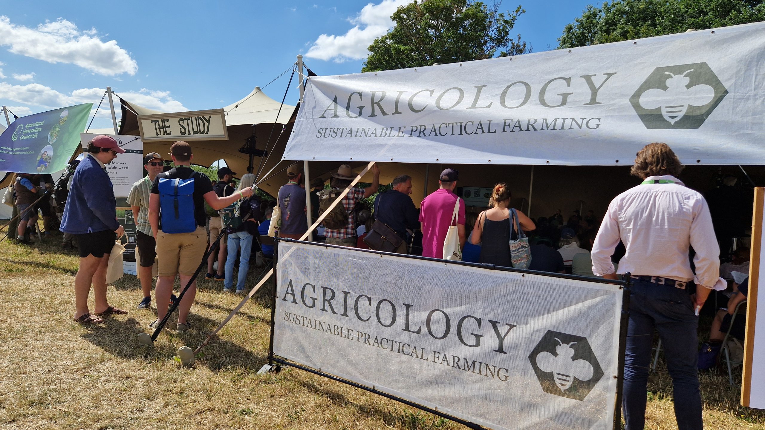 Groundswell attendees outside a tent with Agricology banners